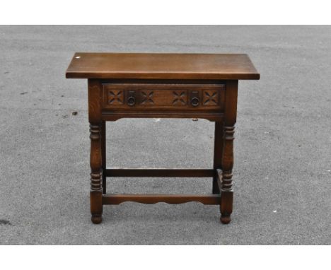 A 17th century style carved and stained oak side table, with drawer, on turned and block legs, height 72cm, width 83cm, depth