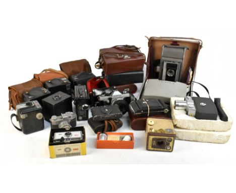 A miscellany of cameras including a Polaroid land camera model J66 with a leather case, a Polaroid automatic 220, a Praktica 