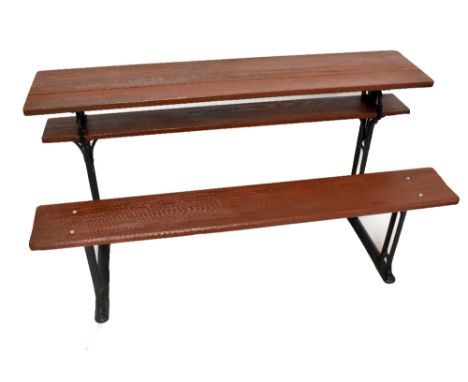 GEO M HAMMER; a patent adjustable cast iron and stained pine school bench, height 76.5cm, width 153cm, depth 67cm.Additional 