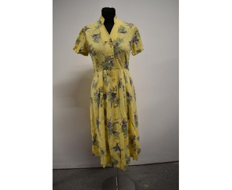 A late 1940s/ early 1950s button down yellow floral cotton shirtwaister dress.