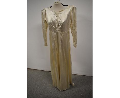 A 1940s Marshall and Snelgrove Southport wedding dress with sweetheart neckline, sash belt to waist, self covered buttons to 
