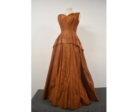 A 1950s copper coloured taffeta evening gown with button detail to skirt, AF.