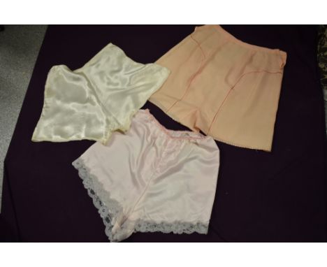 Three pairs of vintage tap pants, including 1930s pink pair with ladder work.