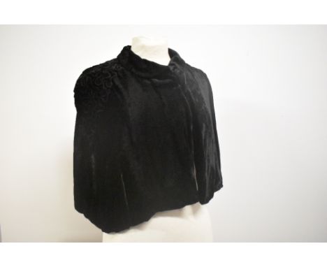 A stunning 1930s black velvet cape with raised soutache braid like detailing to shoulders and large button to fasten.