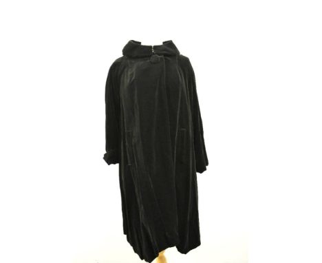 A 1950s Fenwick of Bond street Fair Lady swing coat in black velvet with shawl collar and large button at neckline to fasten.