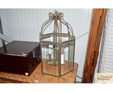 A brass and bevel glass three branch light fitting