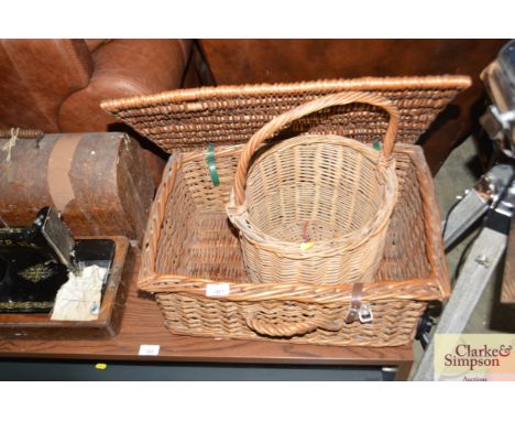 A wicker picnic hamper together with one other wicker basket