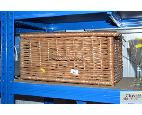 A wicker picnic hamper lacking contents