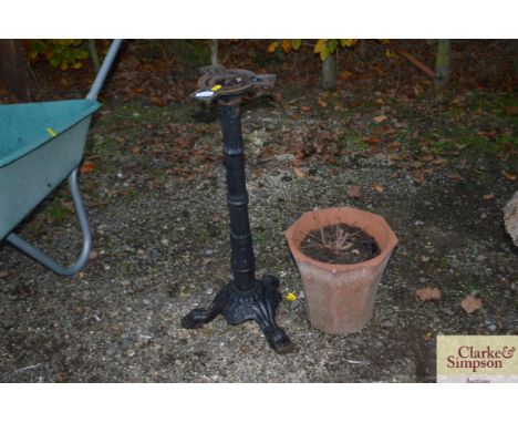  A terracotta planter together with a cast iron stand