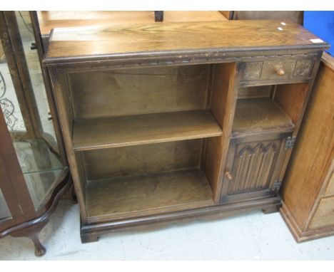 Reproduction oak carved open bookcase with fitted drawer and cupboard on bracket feet. 