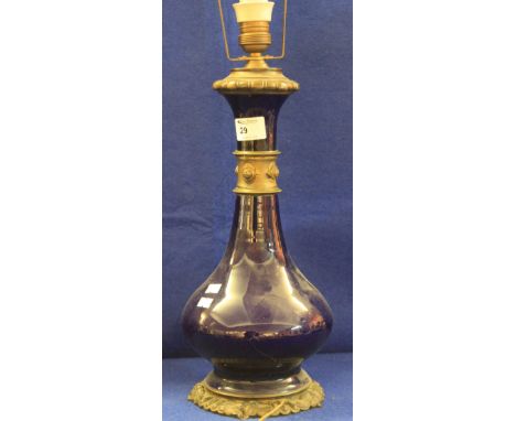 Baluster shaped blue ground ceramic lamp base with yellow metal mounts now for electricity. 