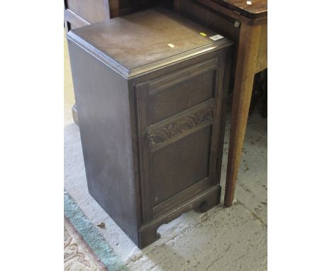 Early 20th century oak carved pot cupboard on bracket feet. 