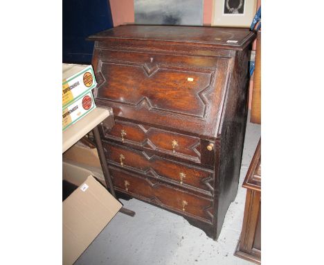 Early 20th century oak Jacobean style fall front bureau with three fitted drawers on bracket feet. 