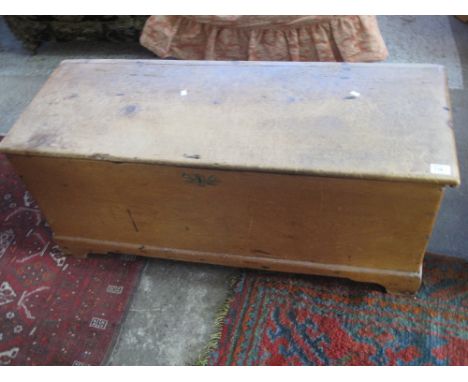 Rectangular pine chest or trunk on bracket feet with metal carrying handles.