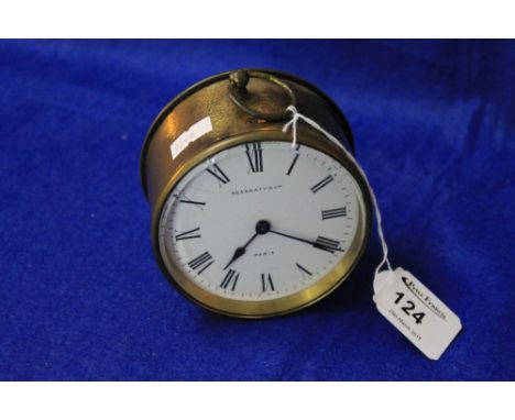 A French brass drum shaped boudoir clock, the enamel face marked 'Skarratt & Co., Paris'. 