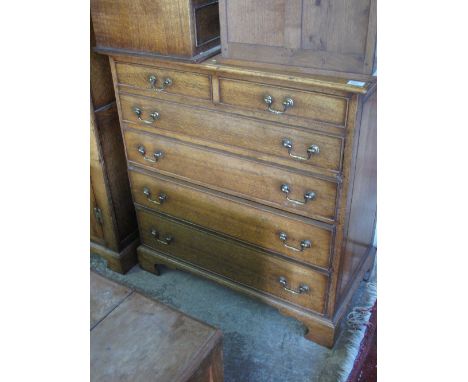 Good quality reproduction oak chest of two short and four long drawers on bracket feet in Georgian style. 
