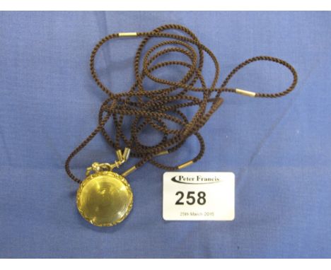 Yellow metal engine turned scroll engraved locket. 
