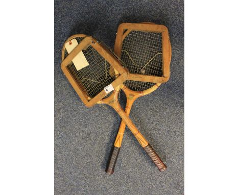 Two vintage wooden tennis rackets with wooden presses. 