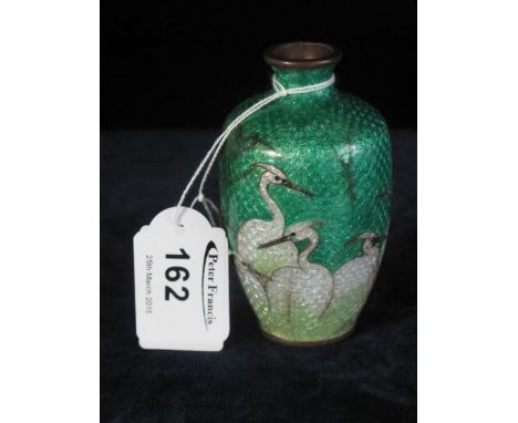 Oriental enamel small baluster vase depicting birds on green ground. Marks to base. 