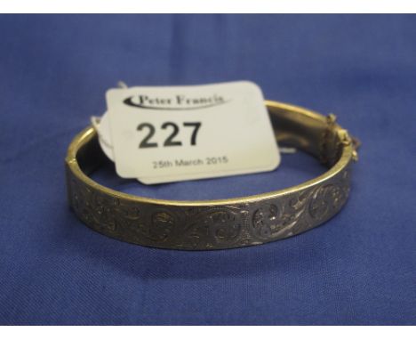 9ct gold scroll engraved bangle.  CONDITION REPORT: Clear hallmarks, minor dents/surface wear.