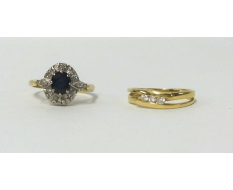 An 18ct diamond set ring and an 18ct sapphire and diamond ring (2), finger size K.