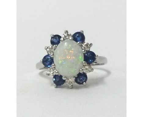 An 18ct white gold cluster ring set with central opal and within a cluster of sapphire and diamonds, thirteen stones in total