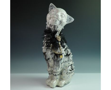 A glamorous mixed-media cat sculpture by Khalil Douisse, featuring an avant-garde Chanel No. 5-inspired design. This striking