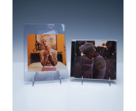 Justin Bieber signed album cover for Justice, accompanied by the official CD release. The autograph, prominently placed on th