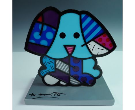 This aluminum sculpture, "Blue Dog Silver Base," by acclaimed Brazilian artist Romero Britto, radiates playful charm and vivi