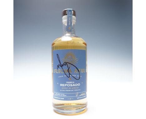 Sealed bottle of Flecha Azul Tequila Reposado, 750ml, 40% ALC. by VOL. This bottle is autographed by Mark Wahlberg, who joine