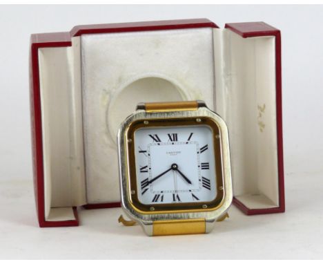 A Cartier stainless steel and gilt travelling clock
Modelled in the form of a Santos wristwatch, quarts movement, impressed m
