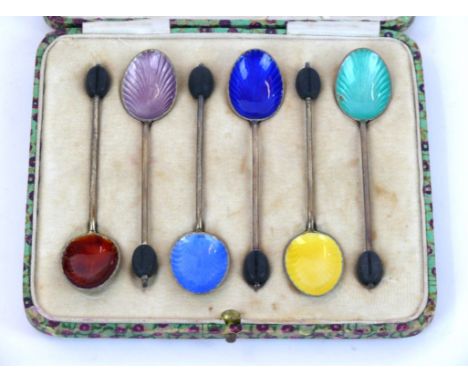 A set of six George V hallmarked silver and enamel coffee bean spoons
Each having open shell enamel decorated bowls in variou