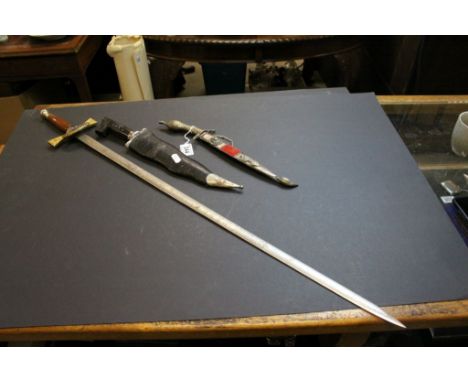 Decorative Sword, blade marked "Wilkinson" with enamel Windsor plaque to the guard and two Middle Eastern Daggers
