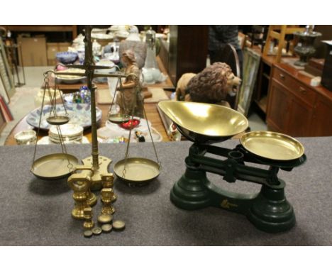 Two vintage sets of scales to include a Brass balance set and painted Cast iron with Brass pans, both sets with Weights