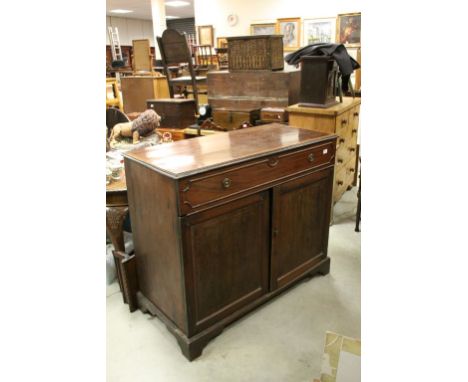 19th century Mahogany Side Cabinet with Long Drawer above Two Panel Doors opening to reveal shelves raised on Bracket Feet, 1