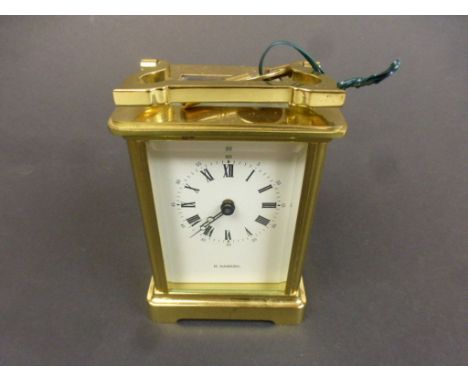 H Samuel brass carriage clock, cream dial with black Arabic numerals, black outer minute track and Arabic numerals, black pok
