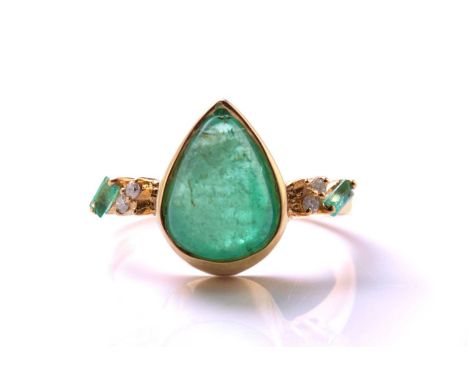 An emerald and diamond 18ct gold ring, centred with a pear-shaped emerald double cabochon, approximately measures 11.6 x 8.2 