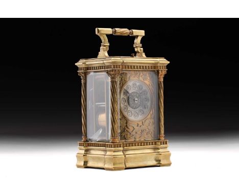 A large early 20th-century French "Anglaise Riche" 8-day repeater carriage clock with a distinctive folding bale handle. The 