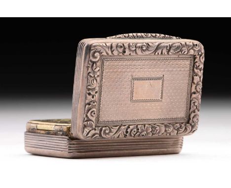 A William IV vinaigrette; rounded rectangular with applied, cast foliate border; engine-turned cover and base around a vacant