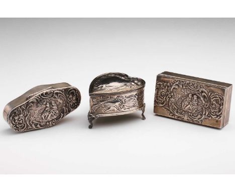 Three Edwardian silver trinket boxes, comprising a shaped rectangular example, the hinged cover repousse decorated with a cla