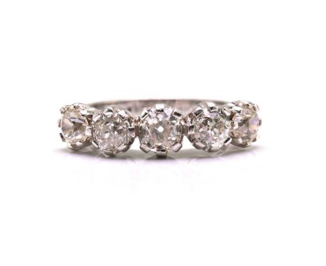 A five-stone Edwardian-style diamond dress ring, comprising one oval and four round old-mine cut diamonds on a coronet settin