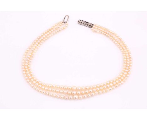 A three-row cultured pearls necklace with an Art Deco diamond-set clasp, consisting of eighty-one, eighty-two and eighty-seve