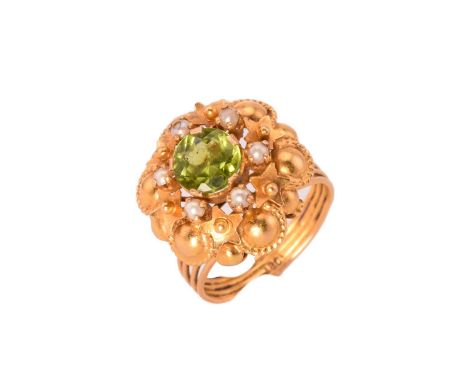 A peridot and split pearl cluster ring, centred with a round faceted peridot, surrounded by split pearls, claw set on an elab