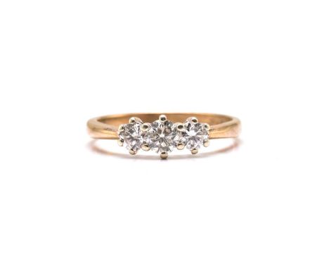 A 9ct gold and three-stone diamond ring, consisting of three brilliant diamonds with an estimated total weight of 0.65ct, app