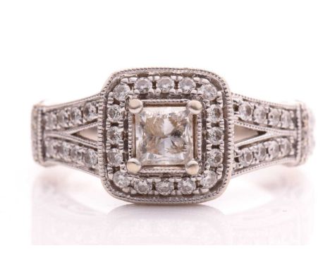 A Vera Wang Love ring with diamonds on 14kt white gold, set with a central princess cut diamond measuring 4.15 x 4.16mm surro