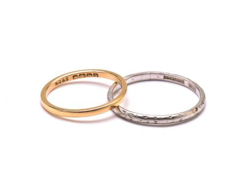 An 18ct gold ring and a platinum ring, the gold ring has a plain court band, stamped 'FIDELITY' inside the shank, Birmingham 