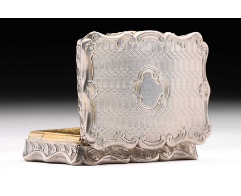 A Victorin vinaigrette; shaped rectangular with scroll-shaped borders, foliate engraved are to edges around an engine turned 