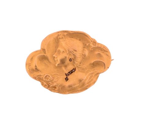 A French Art Nouveau habillé portrait brooch, repoussé depicting a side profile of a lady, with gemstones incorporated in the