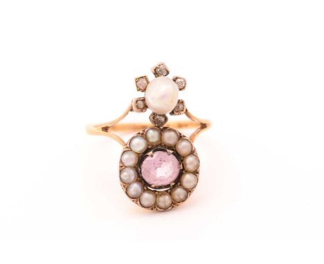 An Edwardian pink topaz and pearl dress ring, featuring an oval-cut pale pink topaz approximately measures 5.9 x 5.1 mm, enci