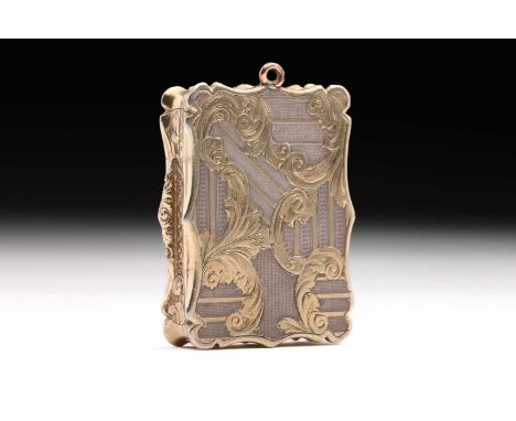 A Victorian parcel-gilt vinaigrette; shaped rectangular, the cover sides and base with engraved gilded scrolls against a segm